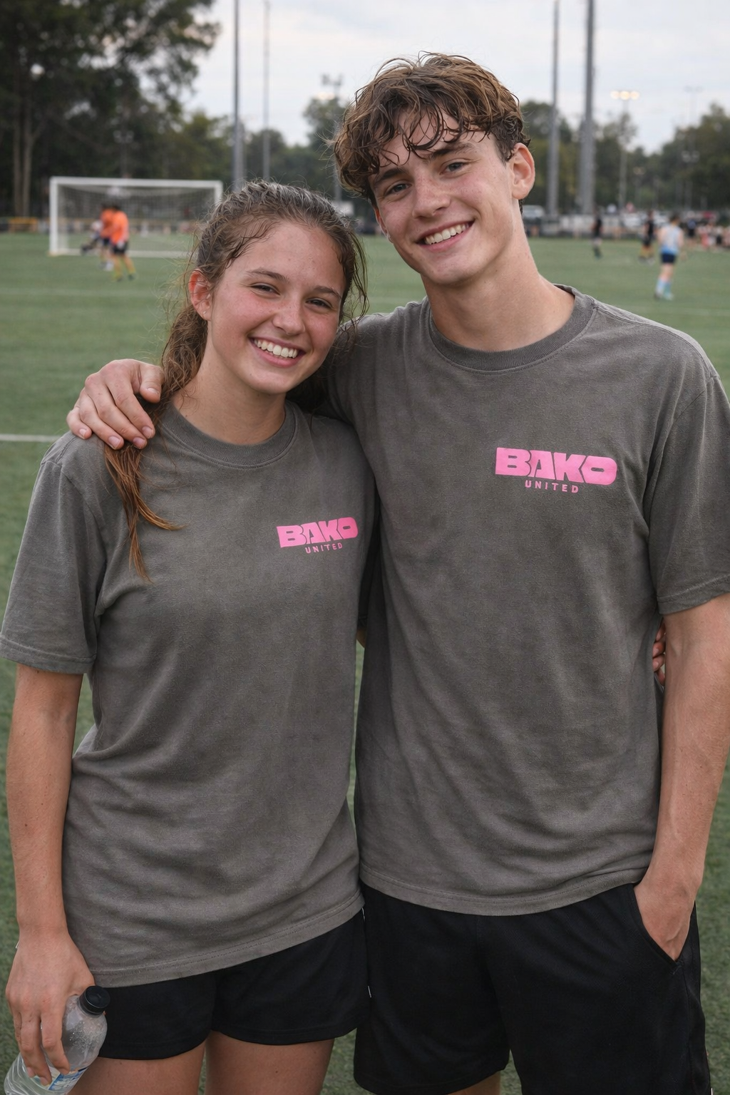 Five young people wearing Bako United tshirts on a sports field.